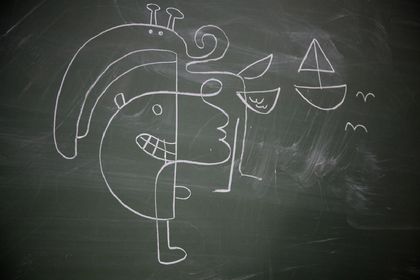 A chalk drawing on a blackboard: a face split into two halves, a sailboat and a bird.