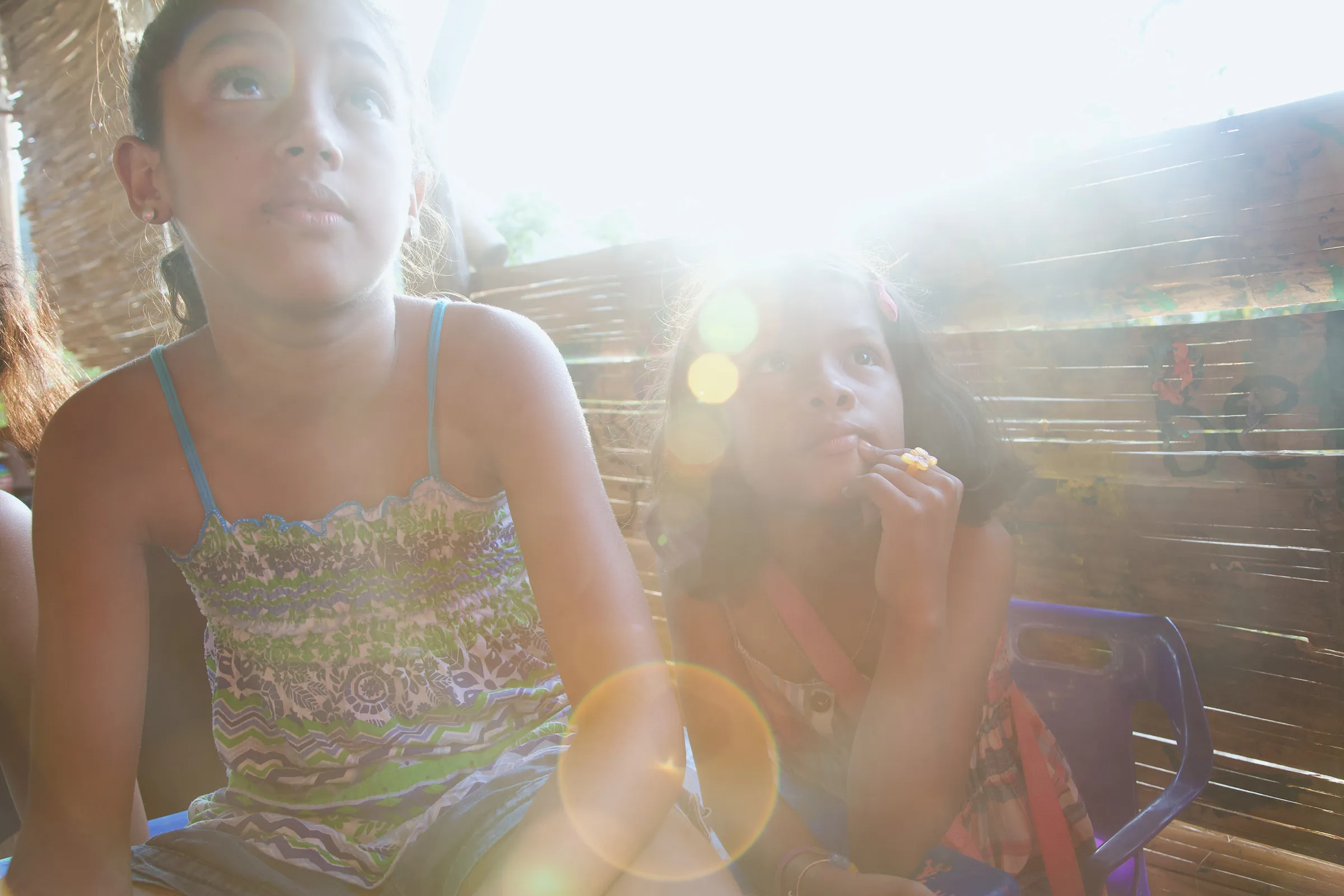 A child looking up in strong backlight.