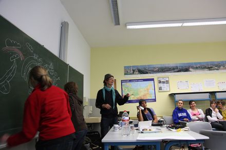 Students draw together at the blackboard while others watch from their seats. Brandenburg, Germany, 2010.